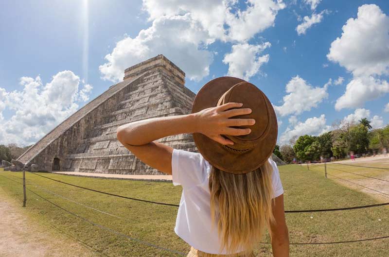 a woman looking at a pyramid