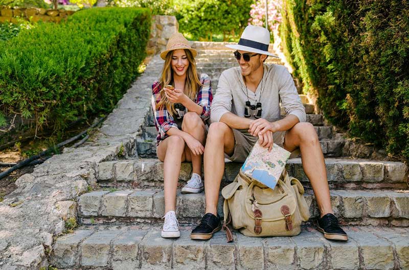 a man and a woman sitting on steps